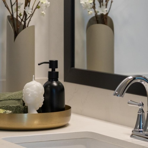 a bathroom with a vase of flowers