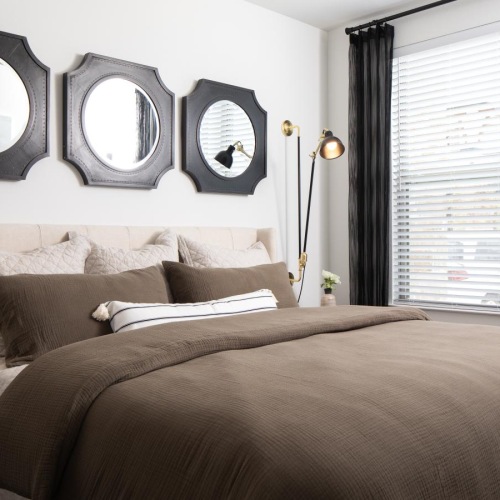 a bed with a mirror above it