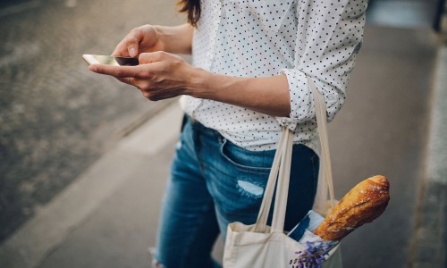 a woman with a bag of groceries